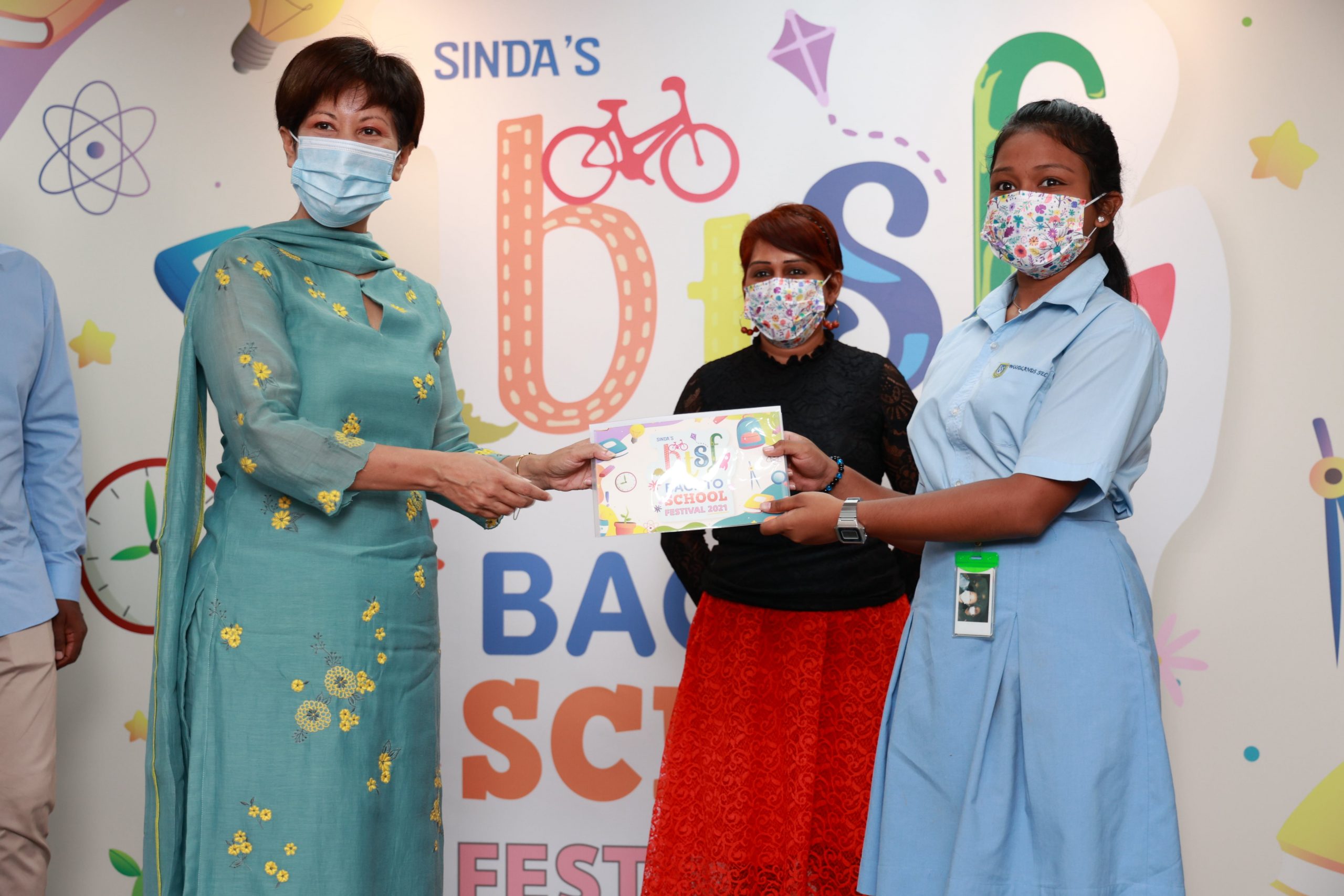 Prisca, 14 (right), from Woodlands Secondary School, one of 4,200 students who received school festival vouchers from Minister Indranee Rajah.
